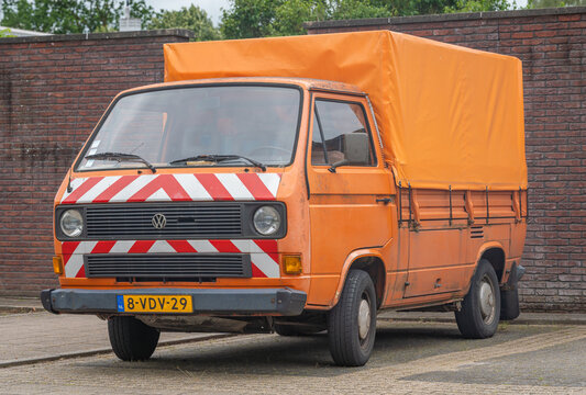 Ede, The Netherlands, 13.06.2026, Orange Volkswagen Transporter T3 Utility from 1987 parked in the street