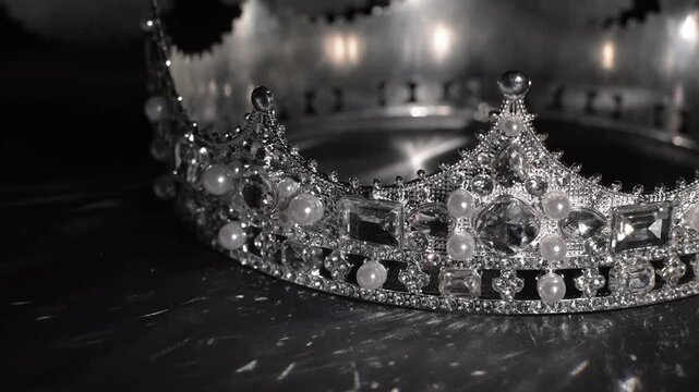 Luxury white gold style crown with sparkling crystals on dark gray silk background.
Elegant luxury crown crafted in white gold style and adorned with sparkling crystals.