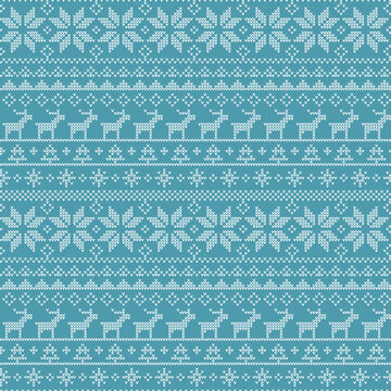 Blue knitted Christmas pattern with white reindeer and snowflake design