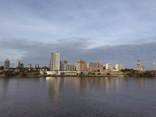 Obraz premium urban landscape. view of city from the sea. buildings and water. reflections.
