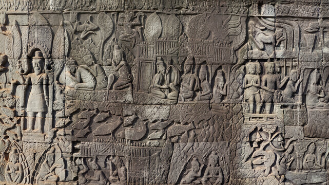 Ancient Khmer bas-relief depicting daily life, battles, and worship in Bayon Temple, Cambodia 