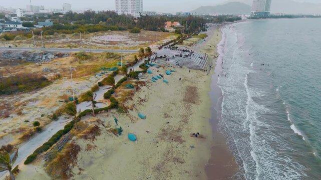Aerial Drone Shot of Coastal City Beach with Basket Boats