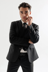 Fototapeta premium Elegant man touching chin and looking forward