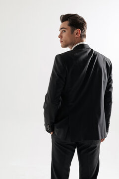 Back view of stylish man in suit looking over shoulder