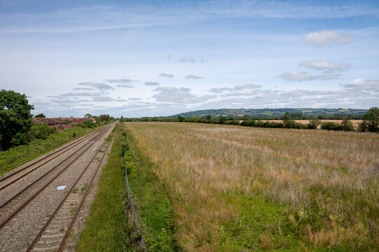 Double-track railway main line running straight through countryside near Ashchurch, Tewkesbury, Gloucestershire