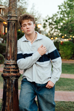 Young Man Leaning on Lamppost