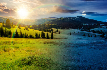 mountainous countryside landscape in summer. day meet night. sun and moon over view of green rural scenery with grassy pastures and rolling forested hills. wonderful mountain weather with cloudy sky © Pellinni