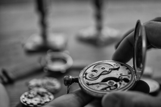 Watchmaker adjusting mechanical watch, repair shop