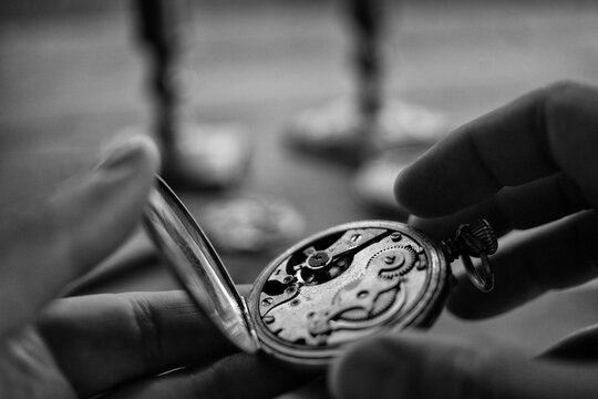 Watchmaker adjusting mechanical watch, repair shop