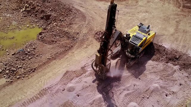 Heavy drilling machinery working at a large infrastructure construction site, preparing the ground with soil stabilization and foundation operations in an excavated road corridor.
