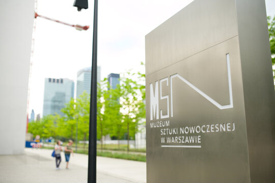 Warsaw, Poland: May 24 2026: Museum of Modern Art in Warsaw (MSN) signpost. Modern metal information pylon with institutional logo against a blurred city background, Poland.