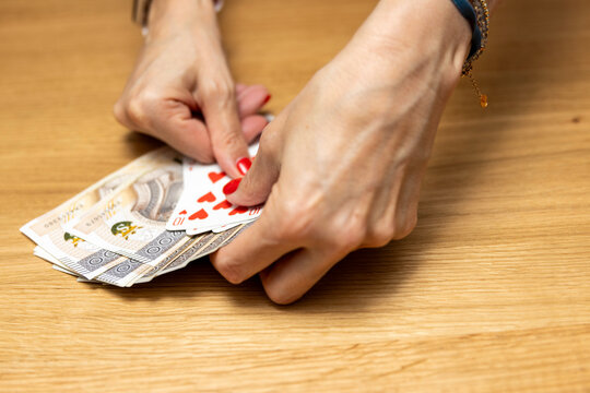 Woman's hands holding a fan of playing cards &mdash; card game, leisure, entertainment