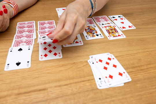 Woman's hands holding a fan of playing cards &mdash; card game, leisure, entertainment