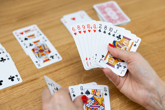 Woman's hands holding a fan of playing cards &mdash; card game, leisure, entertainment