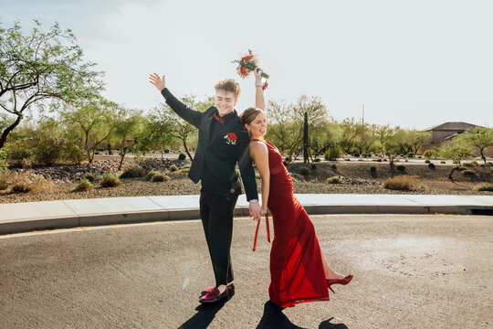 Prom couple celebrating in street