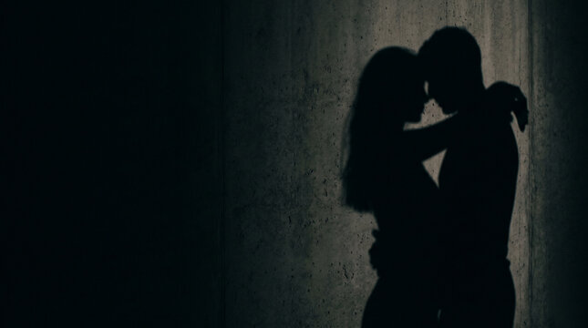 Silhouette of a couple embracing in intimate embrace