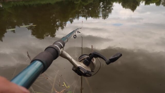 first person view fishing rod in hands