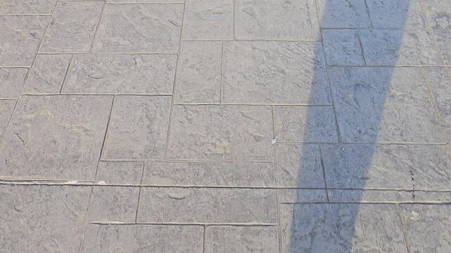 Walking step viewed only the shadow at the road texture video