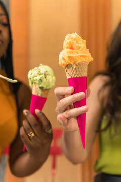 Friends enjoying refreshing gelato cones on a summer day