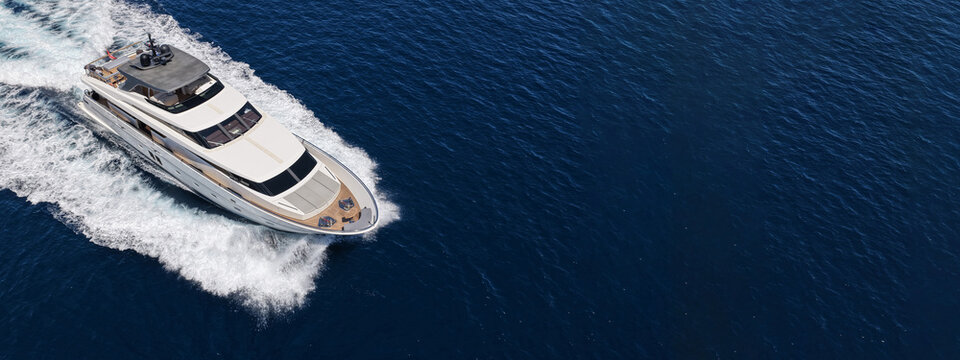 Aerial drone ultra wide photo with copy space of luxury yacht with wooden deck cruising in high speed deep blue Aegean sea