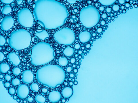 Blue soap bubbles creating abstract liquid texture pattern