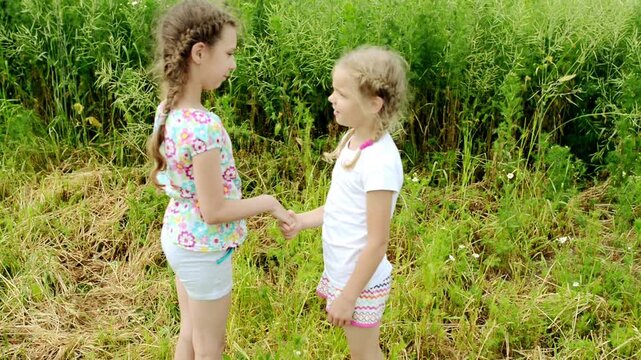 two little girls greet