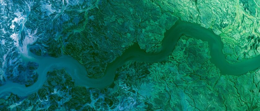 River winding through green landscape showcases nature's design in a remote area during daylight