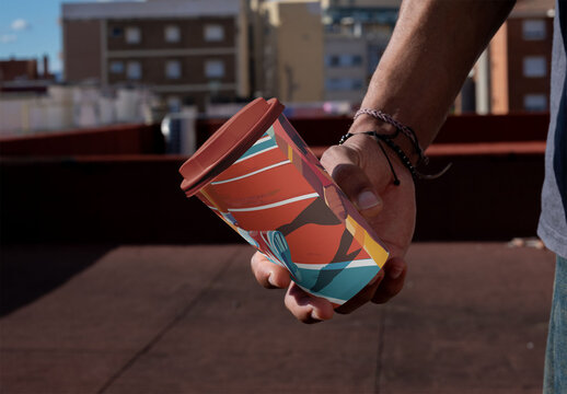 mockup template of Hand holding Eco Disposable take away 