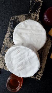 Brie or Camembert cheese is a white, round shape for baking and melting. Camembert cheese as a food background for your design