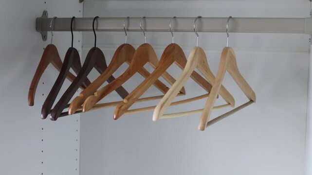Wooden hangers in empty closet, minimalist setup