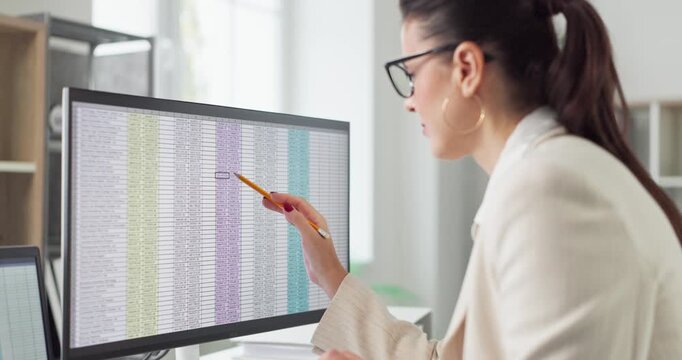 Accountant businesswoman auditor conducts analysis and audit. She reviews finance data on spreadsheet on a monitor in office, verifying figures and planning. Clear concept of audit accounting.