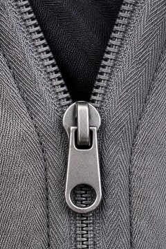 Close-Up of Metallic Zipper on Gray Fabric