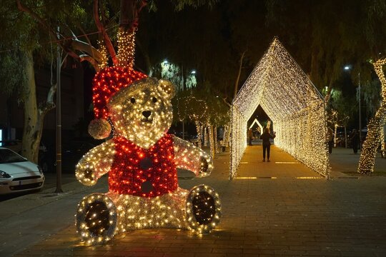 Luminous Santa bear statue and tunnel decorating a street for Christmas, in Glyfada, Greece