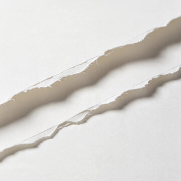 Macro detail of torn white paper edges with fiber texture