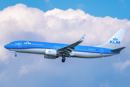 KLM Royal Dutch Airlines Boeing 737-800 passenger jet, registration PH-BGA, descending for landing against a cloudy sky.