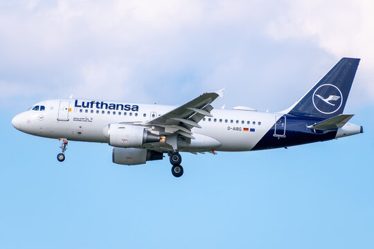 Lufthansa Airbus A319-100 passenger jet, registration D-AIBG, descending for landing against a blue sky.
