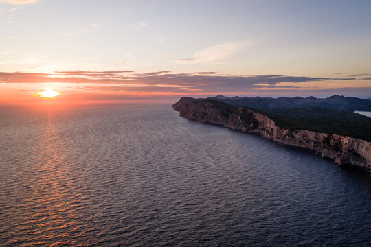Golden sunset over the open Adriatic Sea and dramatic coastal cliffs of Telascica Nature Park, Croatia