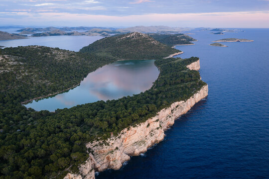Aerial view of Lake Mir and the dramatic seaside cliffs in Telascica Nature Park, Dugi Otok, Croatia
