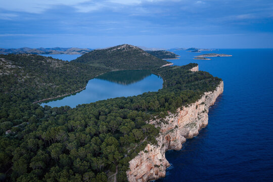 Tranquil twilight aerial view of Lake Mir and the dramatic seaside cliffs in Telascica Nature Park, Dugi Otok, Croatia