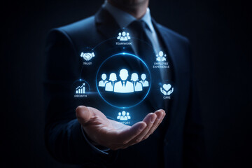 Fototapeta premium Businessman presenting human resources icons over palm in dark studio