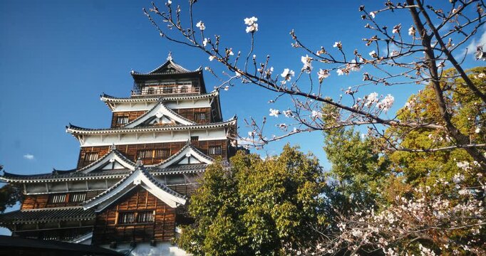 Ancient Hiroshima Castle With Surrounding Spring Cherry Blossoms In Japan
