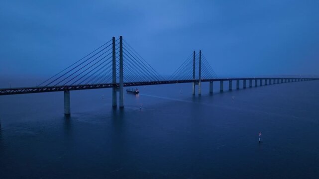 Panoramic Aerial view of Oresund Bridge who is a combined motorway and railway, sea bridge between Denmark and Sweden (Copenhagen and Malmo) and ship - seascape of Baltic Sea, Europe from above