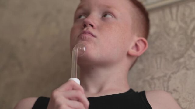 A teenager uses a Darsonval device on their face. Professional skincare at home. Teenage skin problems during hormonal changes. High quality FullHD footage