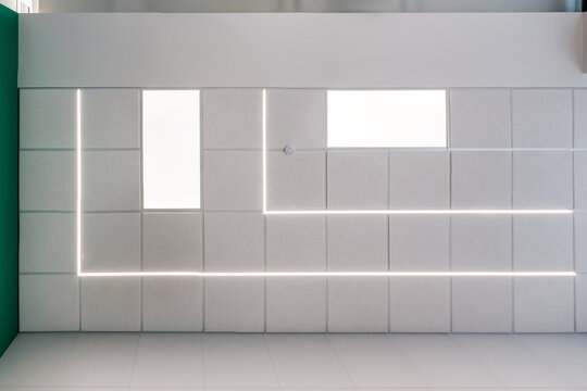 suspended ceiling with halogen spots lamps and drywall construction in empty room in apartment or house. Stretch ceiling white and complex shape.