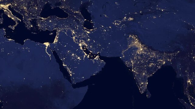 Wide satellite view of the Arabian Peninsula and Strait of Hormuz at night from Earth orbit.