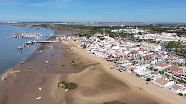 4K drone panoramic view of El Rompido beach, town, lighthouses and La Flecha sandbar