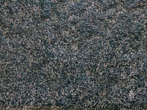 Seamless close up texture of black granite stone or andesite with speckled pattern