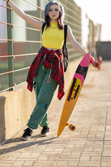 Young woman with skateboard expressing individuality and urban style © KONSTANTIN SHISHKIN
