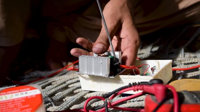 Electrician hands using a screwdriver to fix electrical component wiring , professional maintenance work