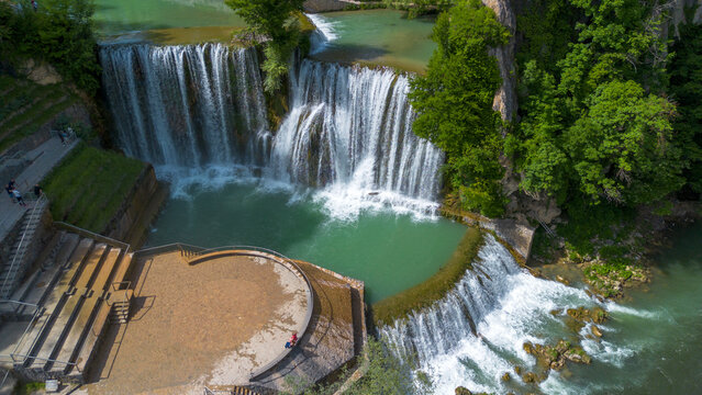 Aerial Drone View of Majestic Pliva Waterfall and Historic Jajce Fortress in Bosnia and Herzegovina